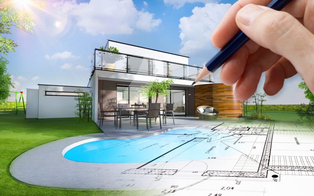 Maison avec main et crayon dessinant un plan de construction